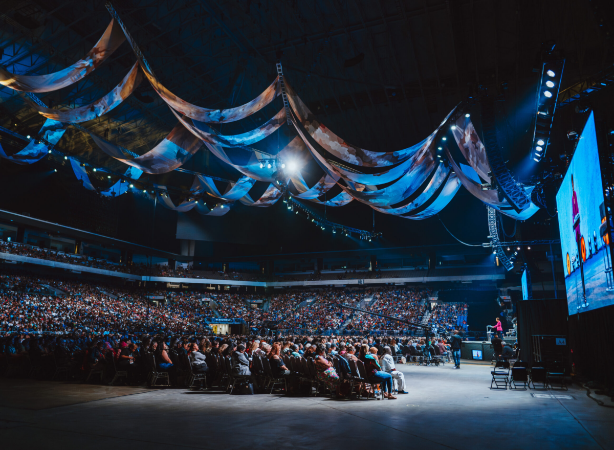 Stadium with crowd and stage.