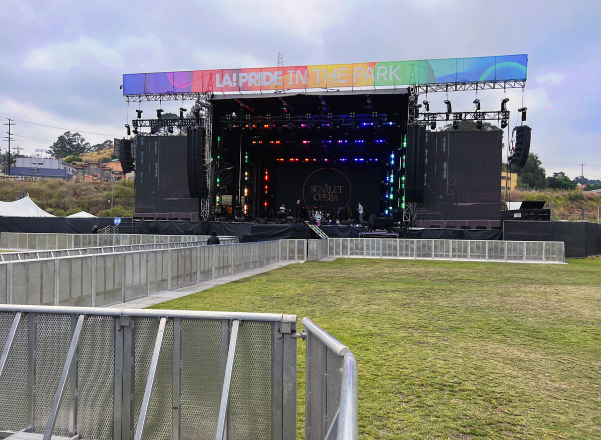 Outdoor stage in field with barrier.