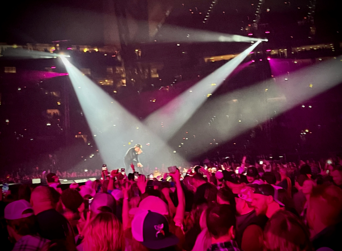 Morgan Wallen with spotlights on him in front of crowd